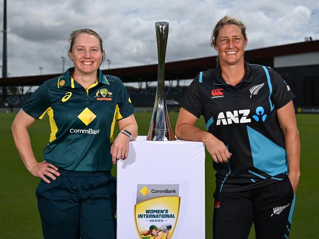 MACKAY, AUSTRALIA - SEPTEMBER 18: Alyssa Healy, captain of Australia and Sophie Devine, captain of New Zealand, pose for portraits with the trophy during a women's T20 International media opportunity at Great Barrier Reef Arena on September 18, 2024 in Mackay, Australia. (Photo by Albert Perez/Getty Images)