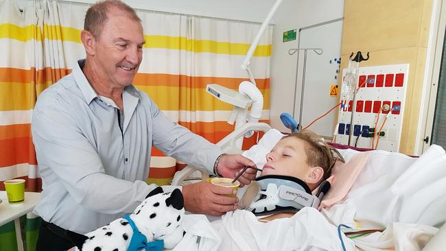 Rugby league Brett Kenny at the bedside of his stepson Riley Hilditch, 16, who suffered severe spinal damage in an accident in February.