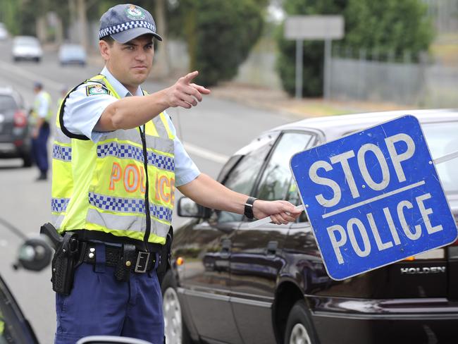 Sen Const Paul Maxwell of the Fairfield Highway Patrol performs RBT on River Ave, Carramar, as part of Operation Lockdown.