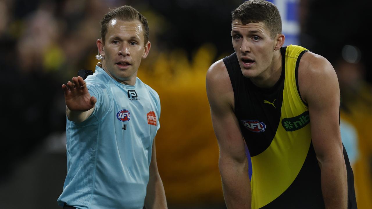 Field umpire Alex Whetton with Richmond’s Ben Miller. Picture: Michael Klein