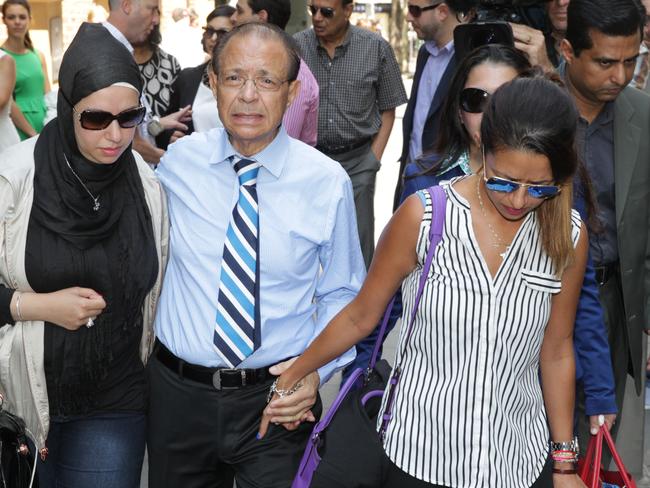 A grief-stricken Dr Khalid Qidwai leaves court after this morning’s sentencing with two of his daughters, including Maha (right), who found her mother’s battered body.