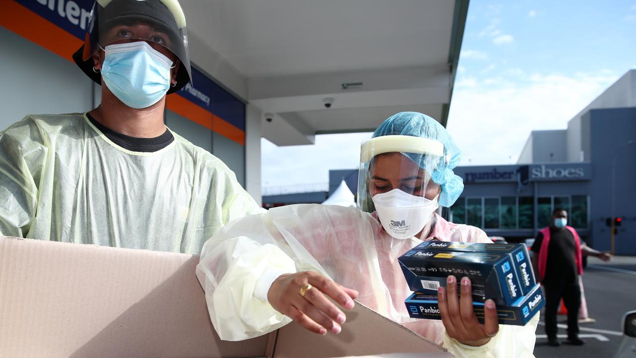 Health workers hand out Covid rapid antigen tests in Auckland, New Zealand. Picture: Fiona Goodall/Getty Images