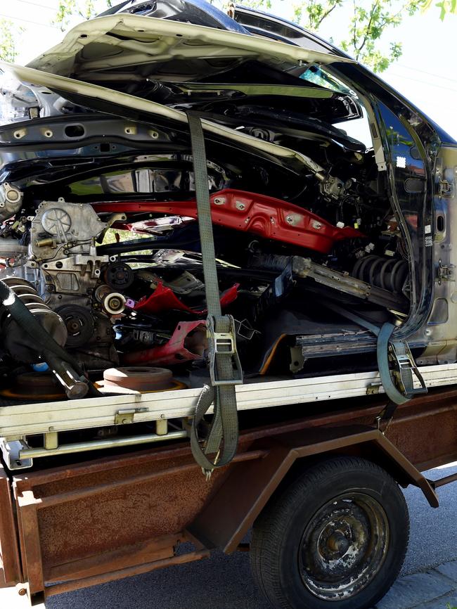 Cars and trailers are loaded up with junk outside Ralph De Masi’s house. Picture: Nicole Garmston