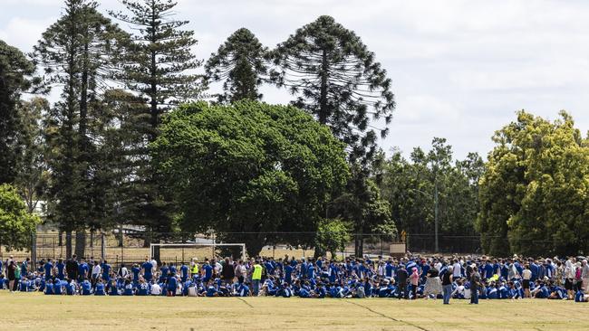 Harristown State High School students and staff on the oval as the school was placed in lockdown after threats were allegedly made to the school. Picture: Kevin Farmer