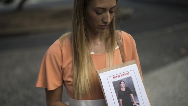 Bonnie Cuthbert shows a photo of her missing boyfriend Rye Hunt, 25, during a press conference in Rio de Janeiro earlier this month. Picture: AP/FELIPE DANA