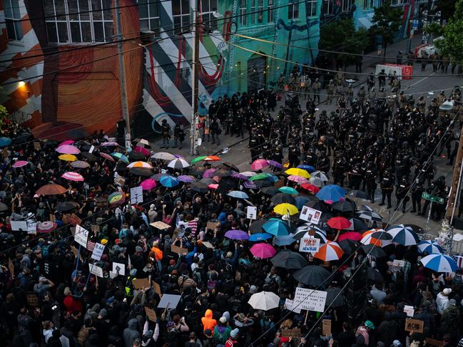 Demonstrators face off with law enforcement personnel near the Seattle Police Departments East Precinct. Picture: AFP