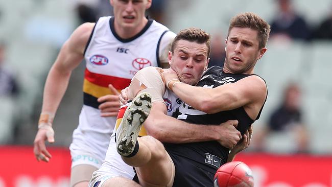 Marc Murphy of the Blues kicks out of mid-air as he tangles with Adelaide's Brad Crouch. Picture: Michael Klein