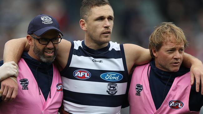 Joel Selwood is helped from the field by trainers. Picture: Getty Images