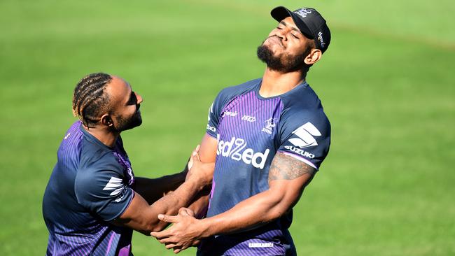 Justin Olam and Tui Kamikamica share a laugh during a Melbourne Storm training session