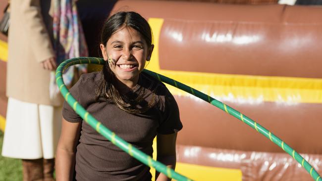 Tigerlilly McCarthy plays with the hula hoops at Sadie's Day Out, a special community event to celebrate the life of five-year-old crash victim Sadie, held at Cambooya State School, Saturday, June 7, 2025. Picture: Kevin Farmer