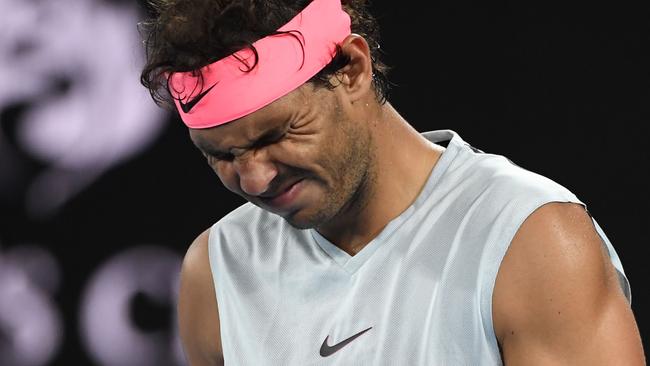 Rafael Nadal grimaces as he walks on court while preparing to serve to Croatia's Marin Cilic.