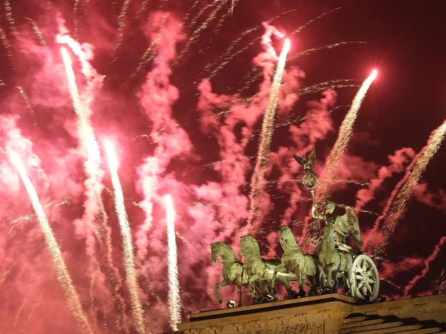 The Quadriga statue stands on the Brandenburg Gate during New Year's Eve fireworks. Picture: Getty