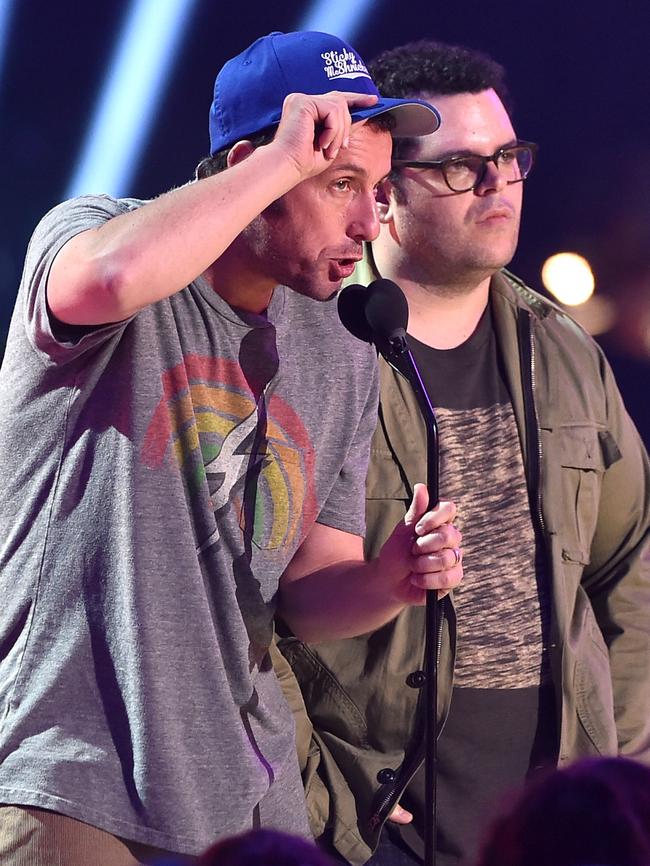 Adam Sandler (L) and Josh Gad speak onstage.