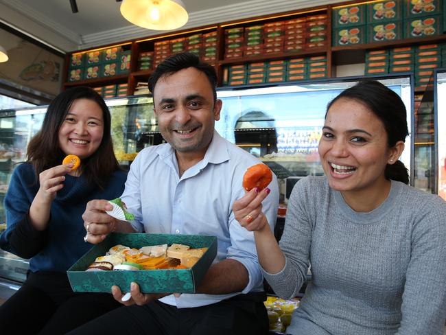 Sweet tooths: Sophia Li, Pratik Patel and Manisha Niraula, at Chatkazz Sweets in Harris Park today. Picture: Tim Hunter