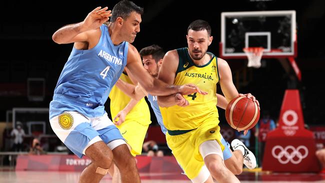 Chris Goulding of Team Australia drives to the basket against Luis Scola #4 of Team Argentina during the second half of a Men's Basketball Quarterfinal game on day eleven of the Tokyo 2020 Olympic Games at Saitama Super Arena on August 03, 2021 in Saitama, Japan. (Photo by Kevin C. Cox/Getty Images)