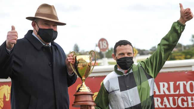 Trainer Peter Moody and jockey Brett Prebble with the Caulfield Cup trophy. Picture: Getty Images