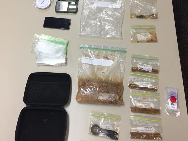 Drugs and items uncovered during a police search in Airlie Beach on Thursday. Police allege more than 1kg of MDMA was uncovered.