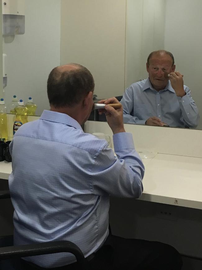 The Daily Telegraph's sports-editor-at-large Phil Rothfield doing his make-up.