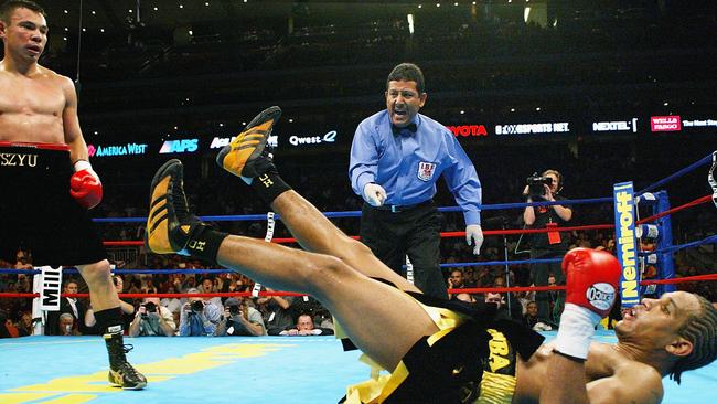 Referee Bobby Ferraro steps in as boxer Kostya Tszyu stands over Sharmba Mitchell during their 2004 fight. Picture: AFP/Getty Images