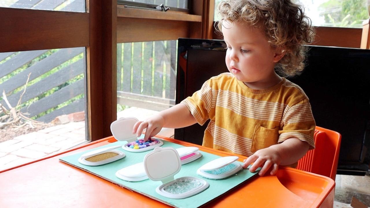 Peek a store boo sensory board