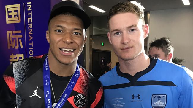 Sydney FC defender Harry Van der Saag (right) pictured with French World Cup winner Kylian Mbappe after making his debut for Sydney against French side PSG.