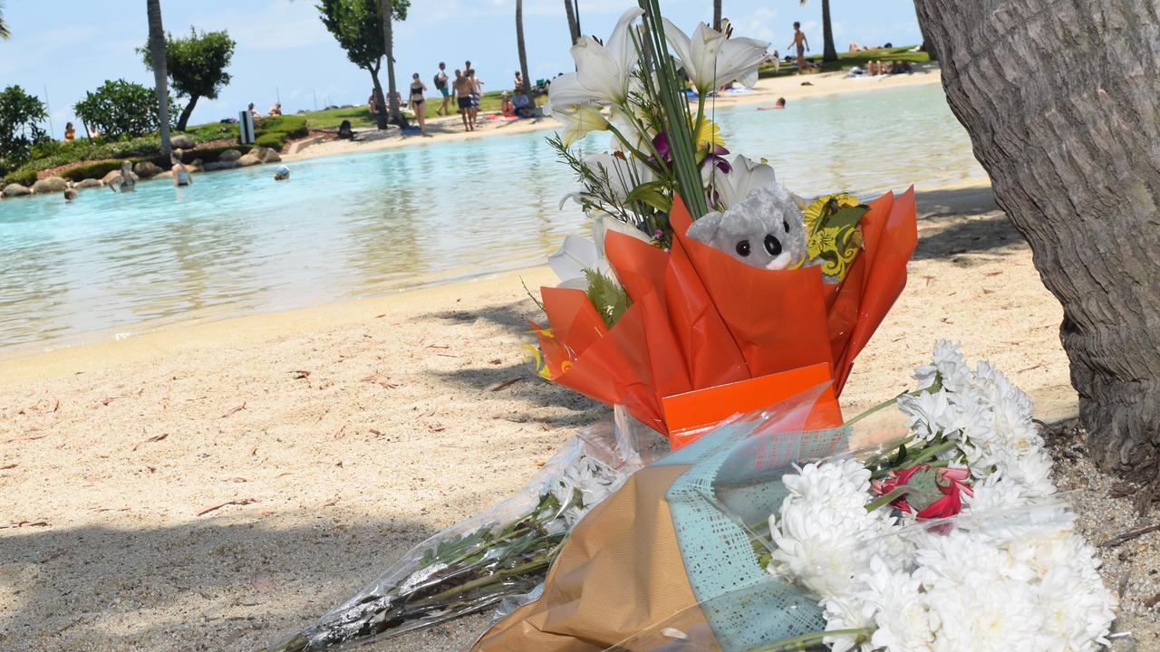 Tributes were left at Airlie Beach Lagoon after a 30-year-old Chinese man and his five-year-old son drowned there on Sunday.