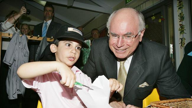 John Howard with one of the preschool students from a Blacktown childcare centre.