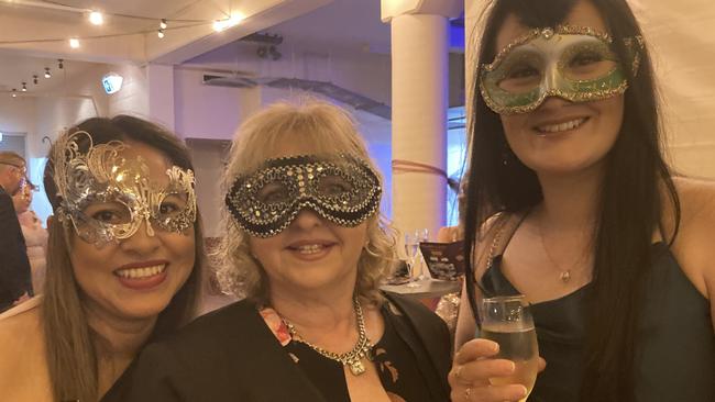 Rosy Gailer and Donna and Hannah Mikita celebrate at the Gympie RSL Masked Ball, April 29 2023.