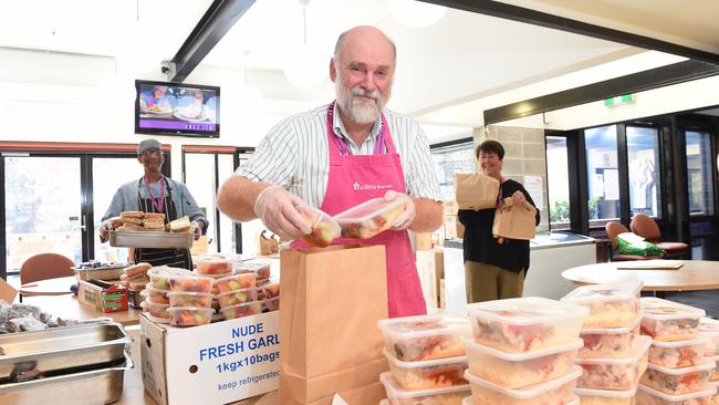 St Mary's House of Welcome staff Doug Ferguson and Jock Allan, with chief executive Robina Bradley, practice social distancing while making emergency food parcels. Picture: Josie Hayden