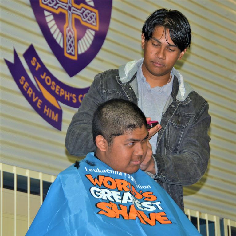 At the St Joseph's College 2023 World's Greatest Shave event is student Johann Ferrer getting his hair cut by his older brother Jeffrey Ferrer. Picture: Rhylea Millar