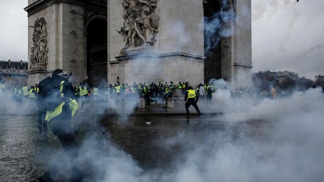 Demonstrators clash with riot police at the Arc de Triomphe. Picture: AFP