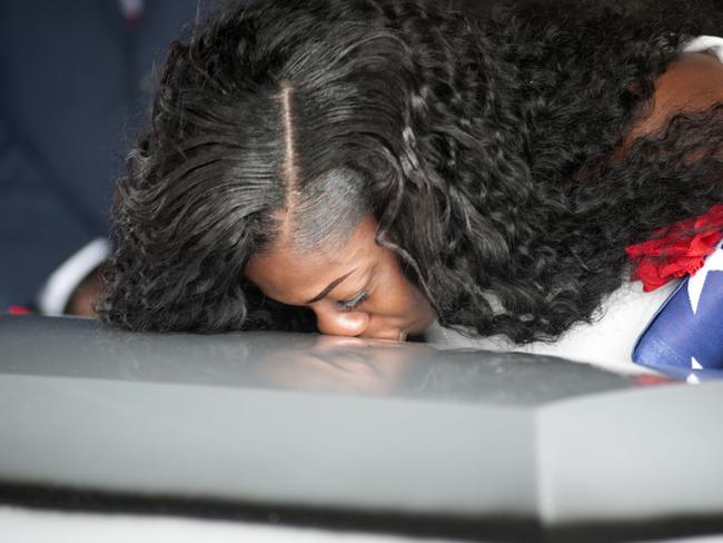 The heartbroken widow pays her respects to her fallen husband. Picture: Gaston De Cardenas/AFP