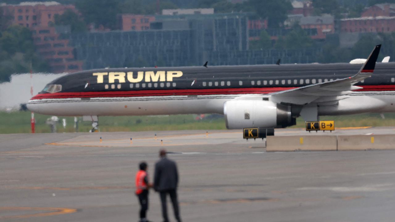 Mr Trump’s aeroplane arrives in Washington DC. (Photo by WIN MCNAMEE / GETTY IMAGES NORTH AMERICA / Getty Images via AFP)