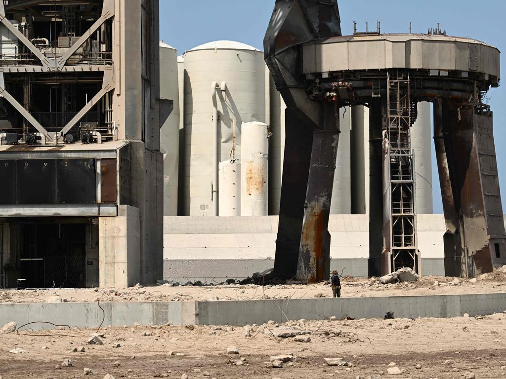 A security guard watches as members of the public inspect the debris. Picture: Patrick T. Fallon/AFP