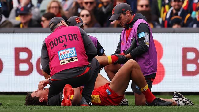 Wil Powell goes down hurt against the Crows. Picture: James Elsby/AFL Photos via Getty Images