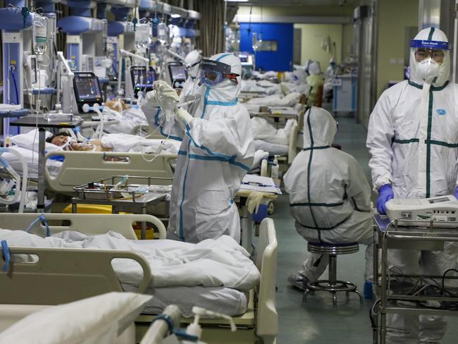 Medical workers treat patients in the isolated intensive care unit at a hospital in Wuhan. Picture: AP