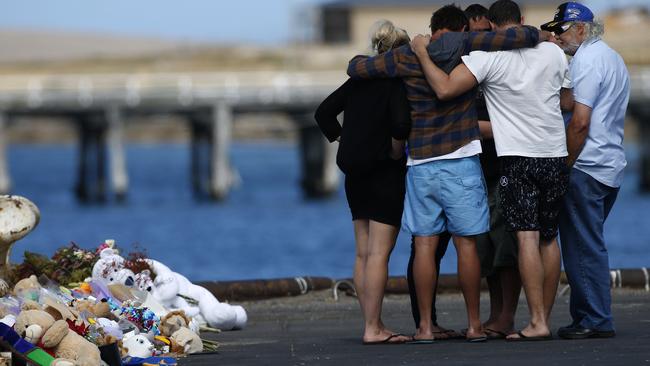 Hunter and Koda’s uncles, and Damien’s brothers, are comforted by family at the scene. Picture: Dean Martin