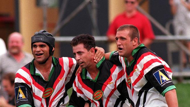 Panthers legend Greg Alexander (centre) is congratulated by teammates after scoring in his first match back with the club in 1997.