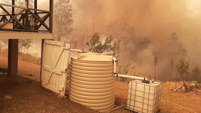 Fire approaching a home in the Kempsey area on Monday afternoon. Picture by Lindsay Rogers.