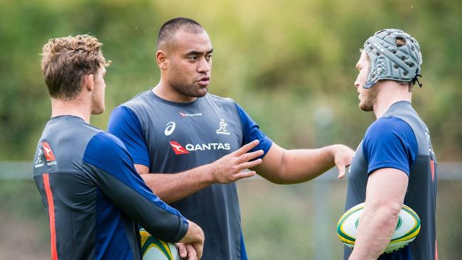 New Wallaby Caleb Timu prepares with Michael Hooper and David Pocock.