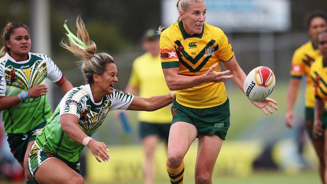 Ali Brigginshaw offloads under pressure from Manea Poa-Maoate of Cook Islands. Picture. Phil Hillyard