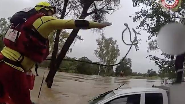 Swift water rescue crews rescued a driver stranded on his ute's roof after his vehicle was swept of the roadway at Balyendo crossing. Image: QFD