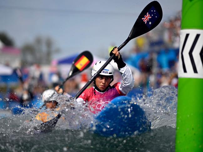 Australia's Noemie Fox races ahead of Spain's Maialen Chourraut in the women's kayak cross heats canoe slalom competition. Picture: AFP