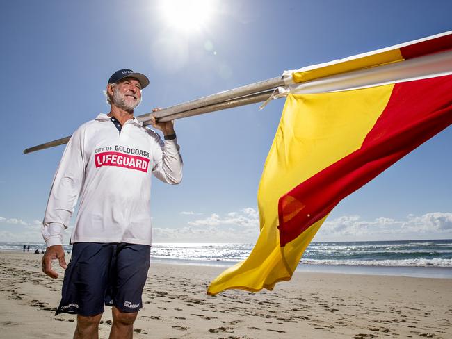 Senior City of Gold Coast Lifeguard Rob Dorrough setting up the red and yellow flags at Surfers Paradise. The flags will offiicially go back up on Saturday across the Gold Coast.  .  Picture: Jerad Williams