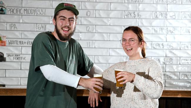 Lachlann Newton and Amber Prout enjoy the new beer Nitro Bee Sting. Aether Brewing have teamed up with an unusual partner for their latest beer – beloved Brisbane bakery Flour &amp; Chocolate Patisserie. Tuesday July 14, 2020. (Picture, John Gass)