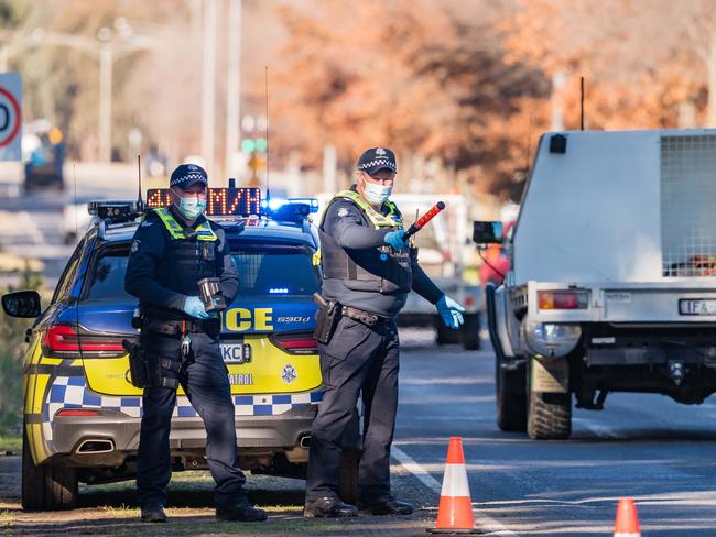 Police check vehicles at the border near Wodonga. Picture: Simon Dallinger