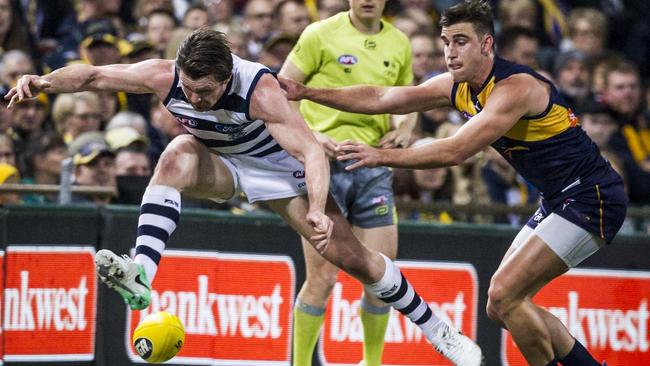 Patrick Dangerfield struggles to get boot to ball with pressure from Elliot Yeo. Picture: AAP