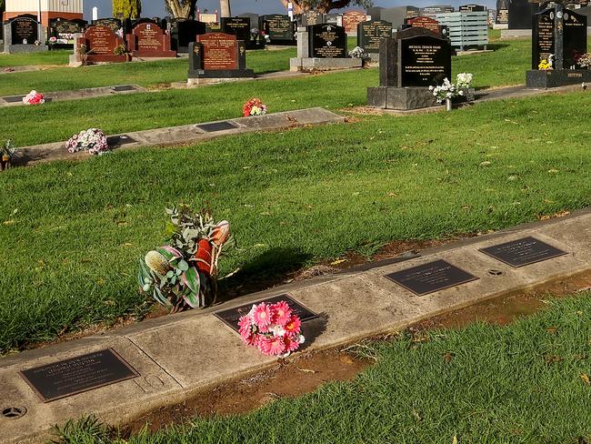 The graves of Don and Gail Patterson, adorned with pink flowers, and Heather Wilkinson in Korumburra General Cemetery. Picture:/Ian Currie