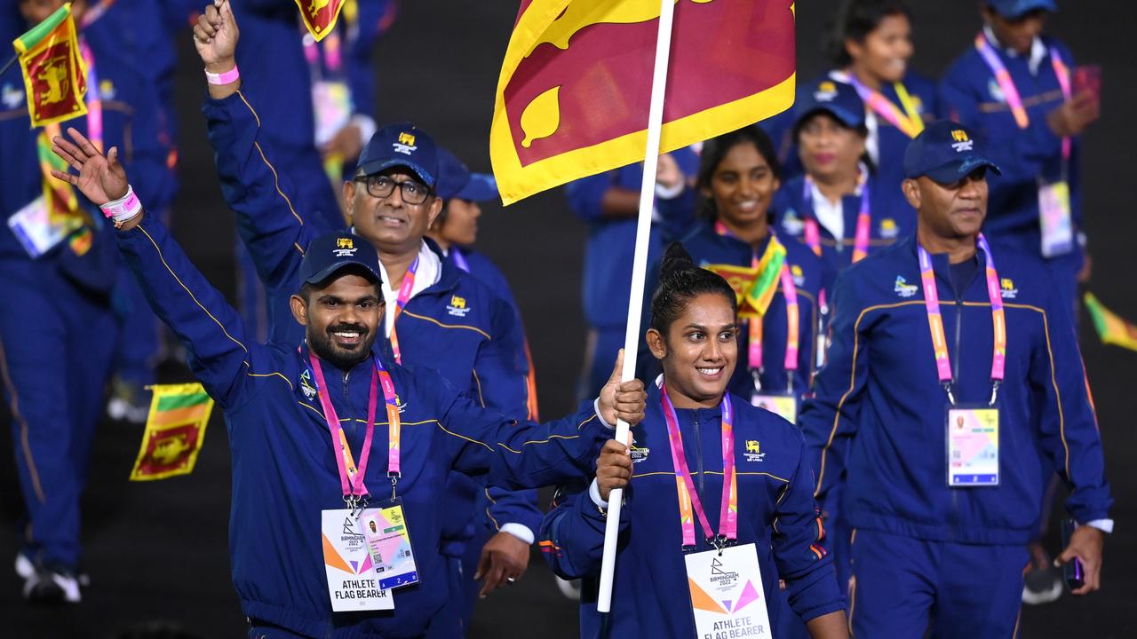 Indika Dissanayake and Chamari Athapaththu carry the flag for the Sri Lankan team. Photo by Alex Davidson/Getty Images.