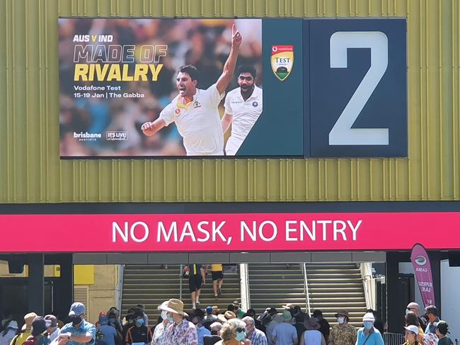 Large signs saying "NO MASK, NO ENTRY" were on display as punters entered the Gabba this morning. Photo: Nathan Edwards